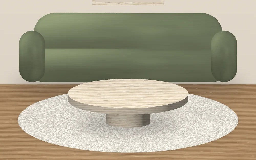 Table basse ronde en travertin devant un canapé en velours sauge, sur un tapis bouclette