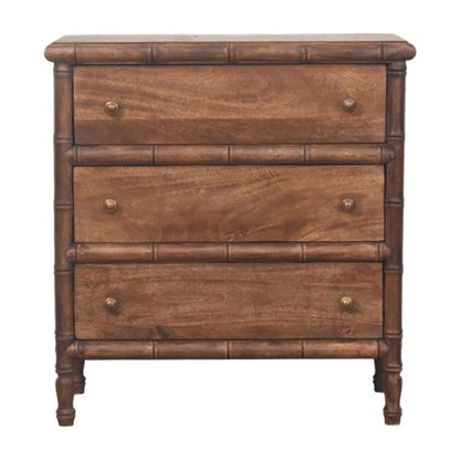 Commode en manguier massif amande grillée, encadrement sculpté façon bambou, trois tiroirs à boutons laiton