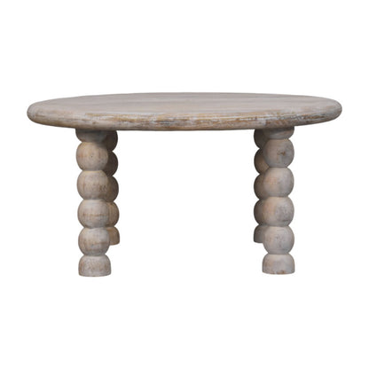 Table basse en manguier massif teinte naturelle, plateau aux contours arrondis et pieds bobine