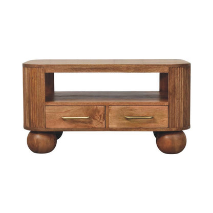 Table basse cannelée en manguier massif teinte miel doré, angles arrondis, pieds boule, tiroirs et étagère